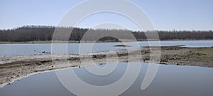 Peaceful Lakeside: Mountains, Trees, and Clear Waters