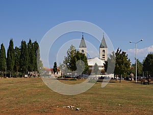 A peaceful landscape in the region of Medjugorje, Bosnia and Herzegovina, with the towers of the church of St. James in the