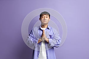 Peaceful Man Meditating at Studio. Portrait of Asian Guy Doing Prayer Gesture