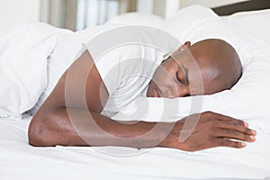 Peaceful man sleeping in bed