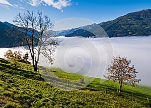 Peaceful misty autumn morning mountain view from hiking path from Dorfgastein to Paarseen lakes, Land Salzburg, Austria