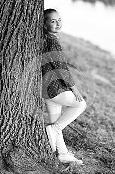 Peaceful mood. Good vibes only. Girl little cute child enjoy peace and tranquility at tree trunk. Place of power