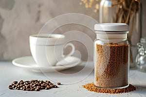 Peaceful morning scene featuring .glass jar filled with ground coffee, white coffee cup on sunlit table. Play of light, shadows