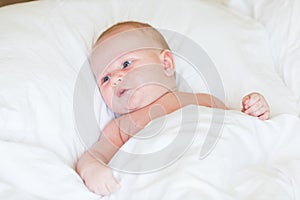 Peaceful newborn baby lying on a bed sleeping