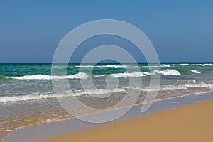 Peaceful ocean wave at beach. Smooth sand