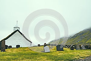 Peaceful old church with fog in Saksun with copy space, Faroe Islands, noth Atlantic ocean, Europe, hidden gem travel destination