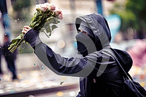 Peaceful Protester Holding a Bouquet of Flowers during a Flower Revolution