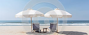 peaceful scene with two beach chairs and umbrellas overlooking the calm ocean