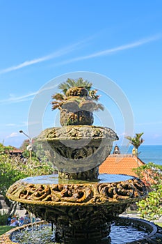 Peaceful scenery with fountain. Park near the Hindu Temple Tanah Lot, Bali, Indonesia. Small decorative fountain in tropical