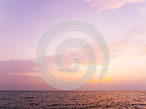 Peaceful sea scape and golden purple tone sunset or sunrise sky, tropical island ocean view at dawn or dusk