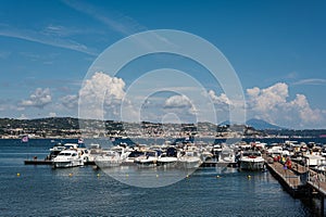 Peaceful sea vacation on a yacht boat in a bay on the Tyrrhenian Sea near Naples. Parking, chartering, board rental