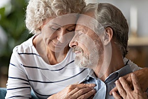 Peaceful senior older family couple soulmates showing love and care.