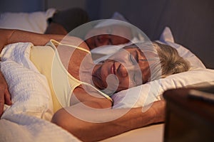 Peaceful Senior Woman Asleep In Bed At Night