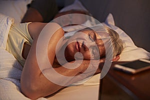 Peaceful Senior Woman Asleep In Bed At Night