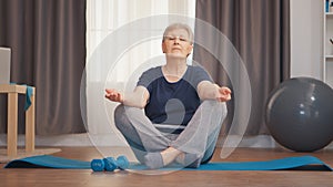 Peaceful senior woman doing yoga