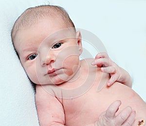 Peaceful serene blue eyed newborn baby