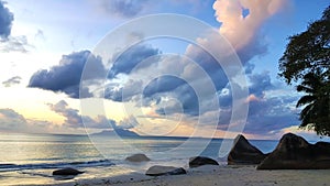 Peaceful Seychelles Beach Sunset with amazing sky and rocks.