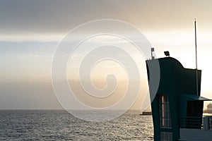 Peaceful and simple view over Mediterranean sea water and silhouette of a modern building in first plan