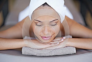 In a peaceful state of mind. a young woman lying on a massage table.