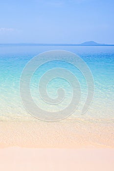 Peaceful summer, turquoise blue seawater and light blue sky, beautiful sand beach and gently waves, island background. Sunshine d