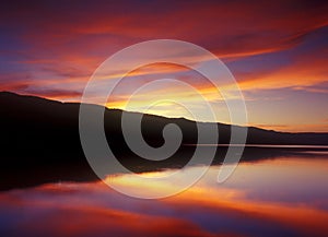 Peaceful Sunset on a Calm Lake photo