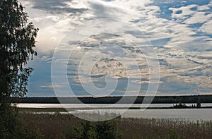 Peaceful sunset by a lake with clouds