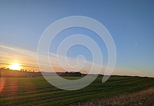 Peaceful sunset over a field of green