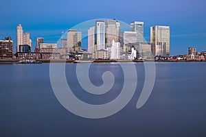 Peaceful sunset in Thames River in East London with Canary district on the background