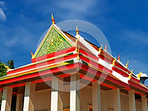 Peaceful Thai temple soaring into blue sky
