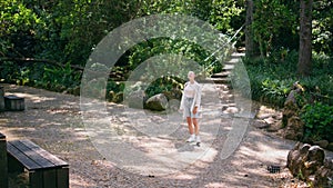 Peaceful tourist enjoy green beautiful forest trees standing recreation place.