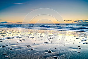 Peaceful and tranquil sunset captured from the beach of North Sea, Netherlands