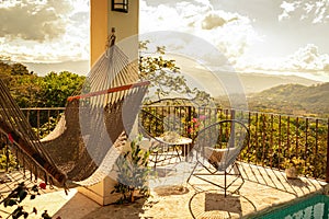 Peaceful view of a hammock on the terrace on the mountains on a beautiful morning in Costa Rica