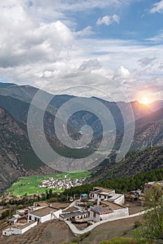A peaceful village surrounded by mountain range valley