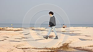 A Peaceful Walk Along Sirmione's Rocky Coastline at Sunset