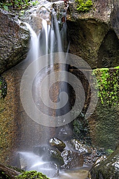 Peaceful water gently wetting the rocks below.