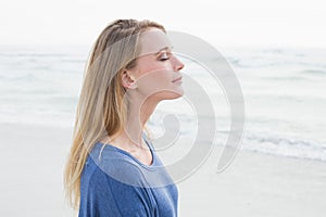 Peaceful woman with eyes closed at beach