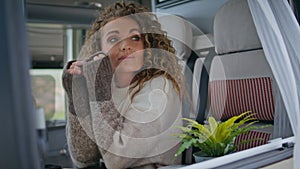 Peaceful woman relaxing motorhome looking window close up. Calm lady sitting van