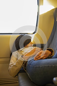 Peaceful young caucasian woman resting and enjoying being alone on the train