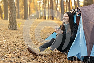 Peaceful young woman drinking tea and looking around