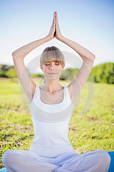 Peaceful young woman relaxing doing yoga