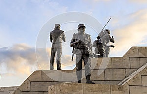 The Peacekeeping Monument, flag of Canada and cloudy sky.