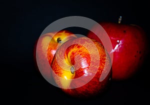 Peach and apple on a blac background. Photo of fruit on a dark background.