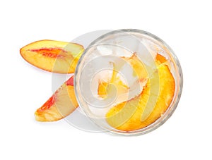 Peach cocktail in glass and fresh fruit