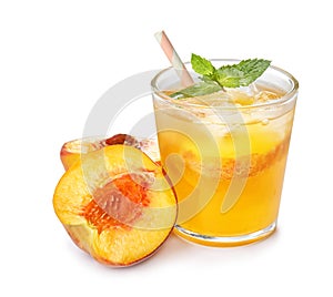 Peach cocktail in glass and fresh fruit