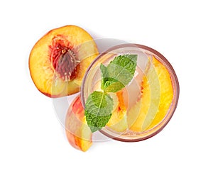 Peach cocktail in glass and fresh fruit