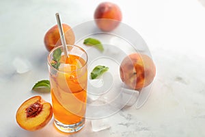 Peach cocktail in glass on light table