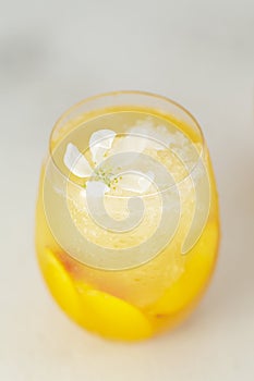 Peach cocktail or tea with ice. Refreshing summer homemade non-alcoholic cocktails.