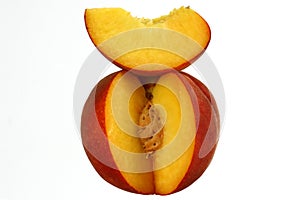 Peach cut with clove and stone, fresh fruit