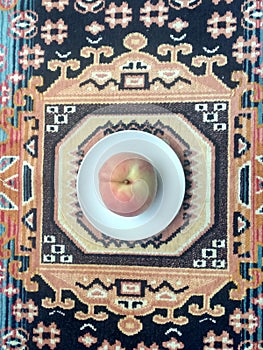 A Peach In The Ethnical Carpet photo