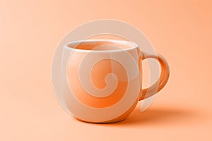 A peach fuzz color mug on minimal background